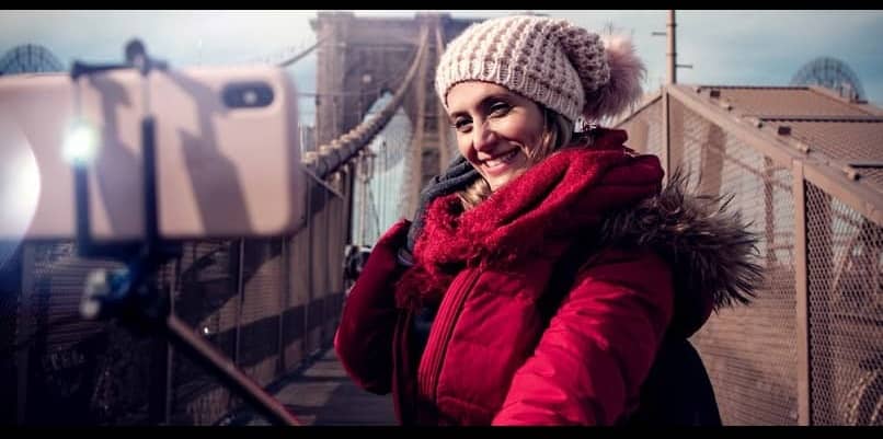 kobieta fotografująca się kijem do selfie